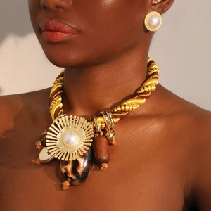 Statement jewelry set with gold rope necklace, leopard beads, and pearl earrings