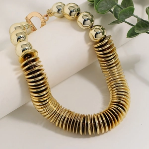 Chunky gold CCB disc necklace with large beads and OT buckle on a white display stand