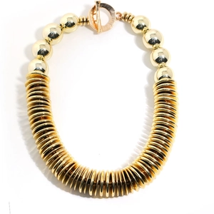 Chunky gold CCB necklace with bold beads, stacked metal discs and toggle clasp closure