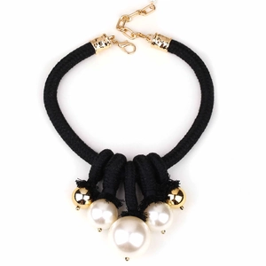 Modern black knotted rope necklace with white pearls and gold beads on white background