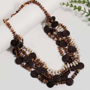 Detailed macro view of retro multi-layered beaded necklace with brown wood and shell accents