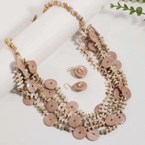Detail of layered brown bead necklace and shell earrings set on a white display stand