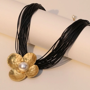 Multi-layer black cord necklace with a gold hammered flower pendant and center pearl inlay
