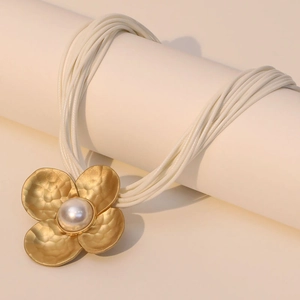 Multi-layer wax cord necklace featuring a large golden flower pendant with a central pearl
