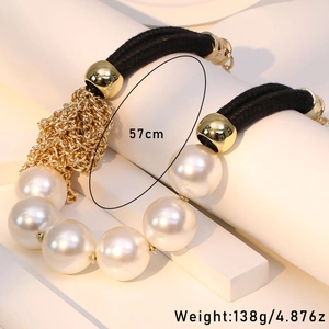 Statement necklace with large imitation pearls, gold metal beads, and black braided rope
