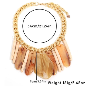 Detail view of resin bar pendants on a chunky gold chain with size and weight labels