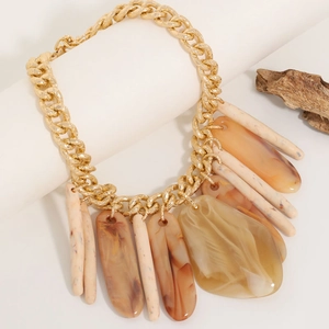 Retro resin long pendant necklace with chunky gold chain on a natural wood display