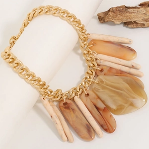 Retro resin pendant necklace with chunky gold chain on a minimalist white display
