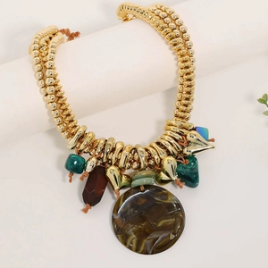 Close-up of gold layered CCB beaded necklace with brown round resin and green charms