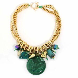 Close-up of golden CCB beaded necklace with large green textured round pendant and charms