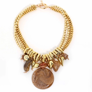 Detailed view of multilayer gold beaded necklace with vintage marble textured pendants