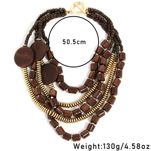 Multi-layer Bohemian necklace with brown wood beads and gold spacers on white background