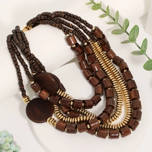 Multi-layer retro necklace with brown wooden beads and gold metal accents on white pedestals