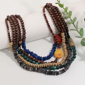 Bohemian multi-layer necklace with wooden beads and blue acrylic stones on white stands
