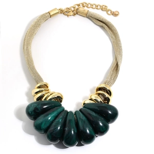 Detail of teardrop green resin pendants with gold mesh chain and adjustable clasp