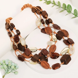 Layered bohemian necklace with multi-colored wood beads and acrylic accents on display