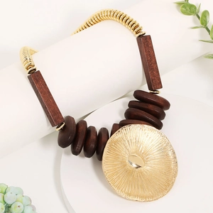 Handmade chunky necklace with wooden beads and large gold-tone leaf pendant