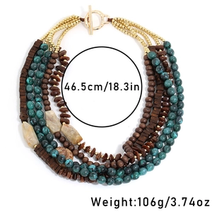 Detail of bohemian multi-layer necklace with green marble beads and wood accents