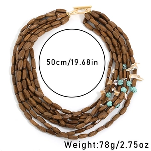 Detail of multilayer wood bead necklace with shell accents and toggle clasp closure