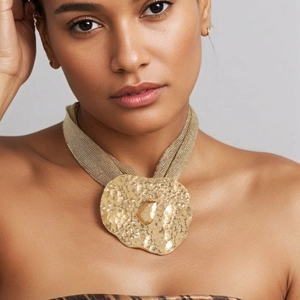 Statement golden mesh chain necklace featuring a large hammered pendant with amber gemstone