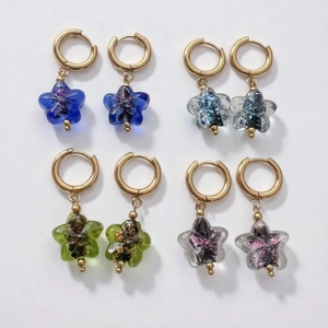 Star-shaped crystal glass charms on gold stainless steel hoop earrings in four colors