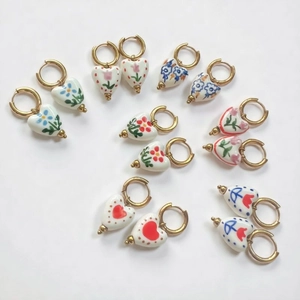18K gold plated heart ceramic earrings with vintage floral patterns on a white background