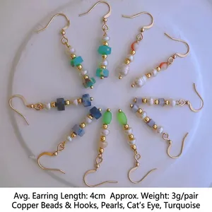 Retro tassel pearl earrings with colorful cat eye stones and turquoise on a stone tray