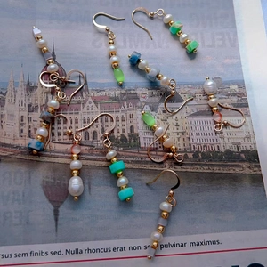 Retro beaded tassel drop earrings with pearls and turquoise beads on magazine background