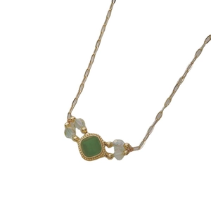 Vintage green cat-eye pendant necklace with gold chain and clear beads in a square design