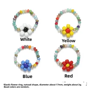 Elastic handmade seed bead rings with colorful flower designs in red, blue, white and yellow
