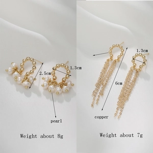 14K gold baroque pearl cluster studs and C-ring tassel earrings on white fabric