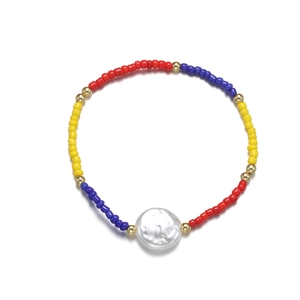 Detail of bohemian stretch bracelet with colorful seed beads and large white baroque pearl