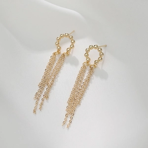 14K gold baroque pearl C-ring tassel earrings with beaded design on white fabric