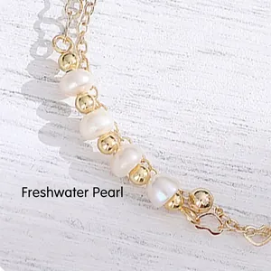 Double-layer 14K gold chain bracelet with freshwater pearls and a heart pendant charm