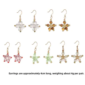 Five pairs of floral and star drop earrings with pink opal beads and gold hooks