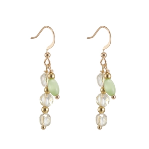 Detailed view of handmade gold drop earrings with cat eye stones and freshwater pearls
