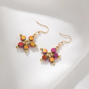 Macro detail of aurora pink cat eye flower earrings with golden beads and hooks