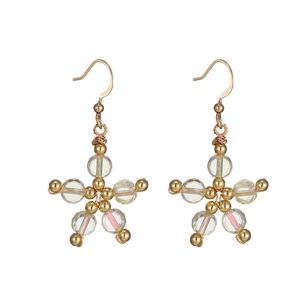 Vintage gold star-shaped earrings with iridescent clear crystal beads on white background