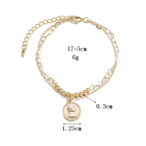 Golden 14K layered coin bracelet with heart chains and classic portrait pendant