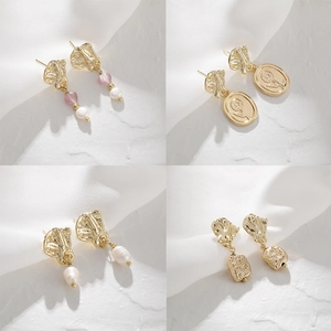 Four pairs of vintage 14K gold pearl earrings featuring irregular textured metal designs