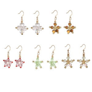 Detailed set of 5 pairs of handmade pearl and star earrings with golden hooks
