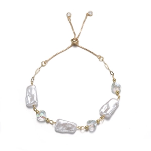 Baroque pearl and crystal heart adjustable gold bracelet on a clean white background