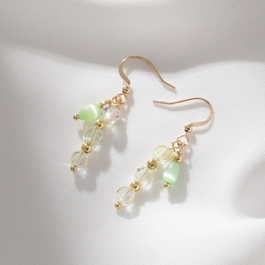 Vintage style cat eye stone pendant earrings with transparent crystals on white silk