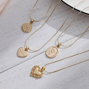 Titanium steel 14K gold necklaces with evil eye and heart pendants on snake chains