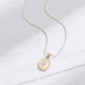 Vintage 14K vergoldete Halskette mit Sonnenblumen-Anhänger und Schlangenkette auf Holzgrund