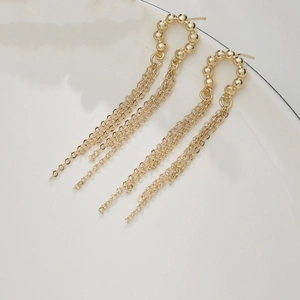 Elegant 14K gold plated tassel earrings with chain drop and beaded design on white background