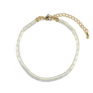 Detail of beaded bracelet with clear rectangular beads and golden adjustable lobster clasp