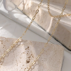 Vintage 18K gold paperclip chain necklace with minimalist geometric oval links on stone