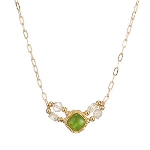 Vintage gold necklace featuring a square green gemstone pendant and beaded accents