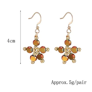 Handmade iridescent orange flower star earrings with gold beads, 4cm long and 5g per pair